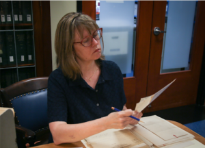Dr. Scales examining documents